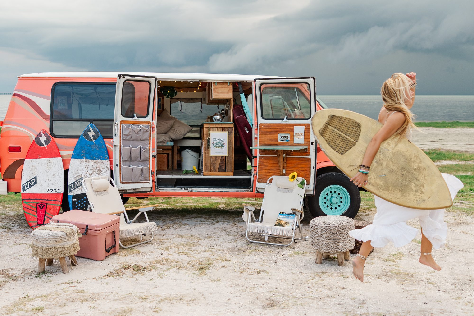 stay wild camper van parked near the beach with surfboards